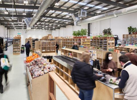 Inside the Brunswick shop — produce and shelves under a high ceiling